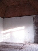 5. Inside stable showing plastered wall and timber ceiling.jpg