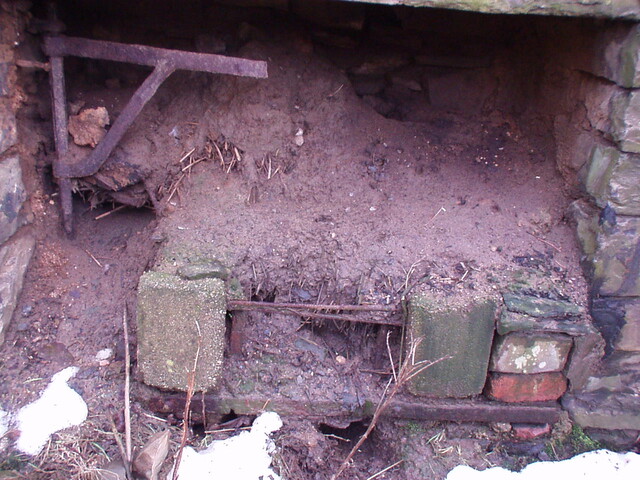 22. Fireplace on right hand side, with some ironwork still i.JPG