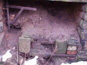 22. Fireplace on right hand side, with some ironwork still i.JPG