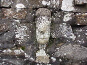 47. Carved stone face set into wall on right hand side of ga.JPG