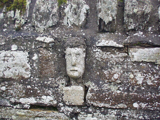 48. Carved stone face set into wall on left hand side of gat.JPG