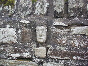 48. Carved stone face set into wall on left hand side of gat.JPG